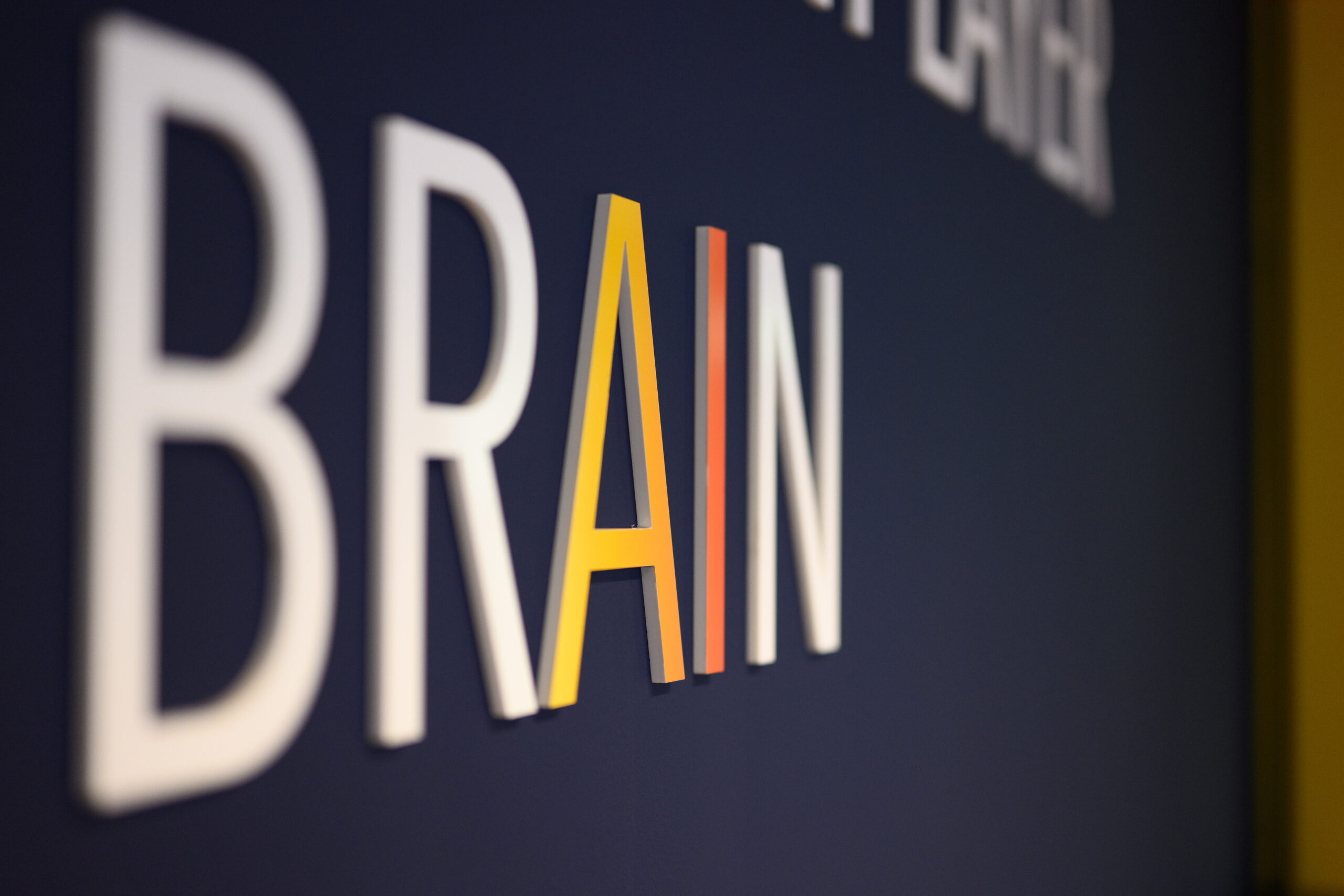 Close-up of the word “BRAIN” on a Wattvise office wall, representing intelligent energy control